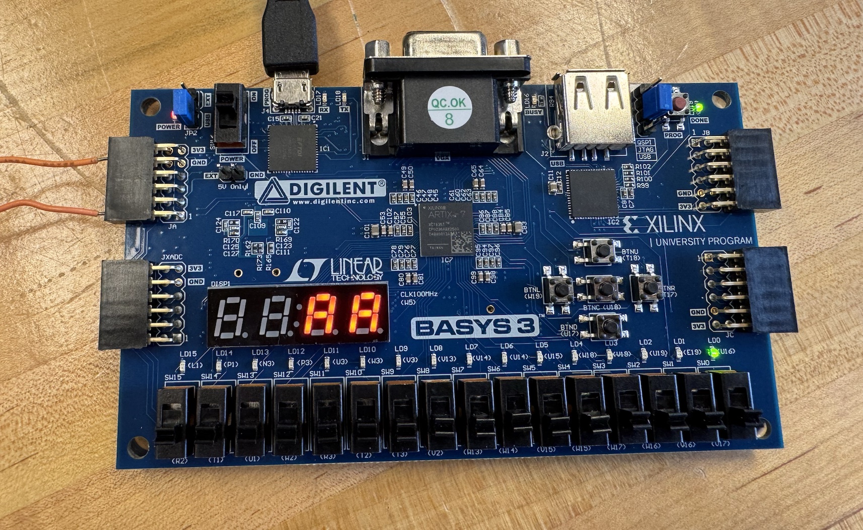 FPGA music player on a blue development board with its seven-segment display lit