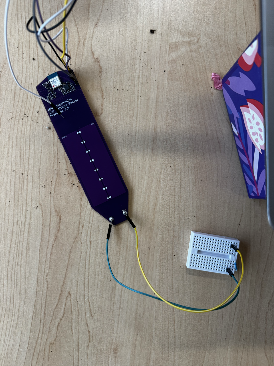 Soil sensor wired to a reference resistor on a breadboard